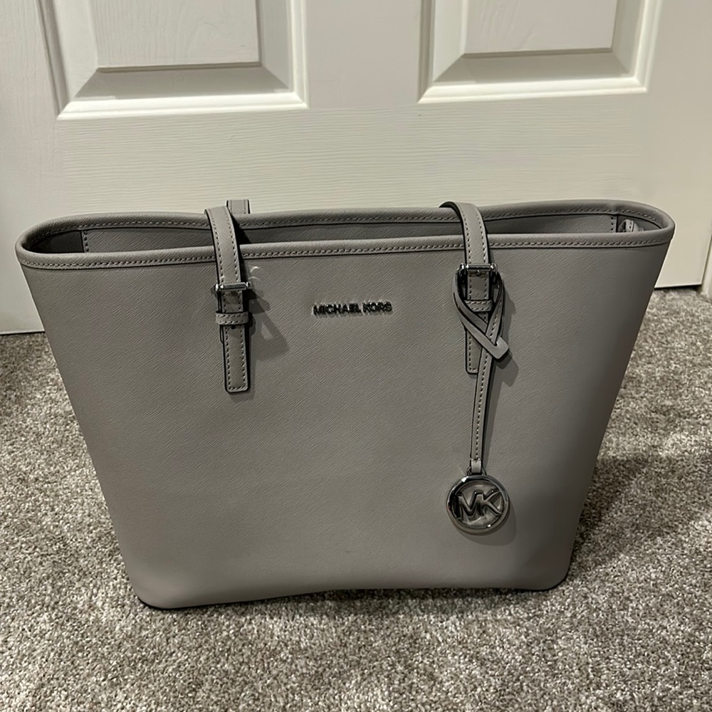 Grey colored Michael Kors purse. Used in good condition.